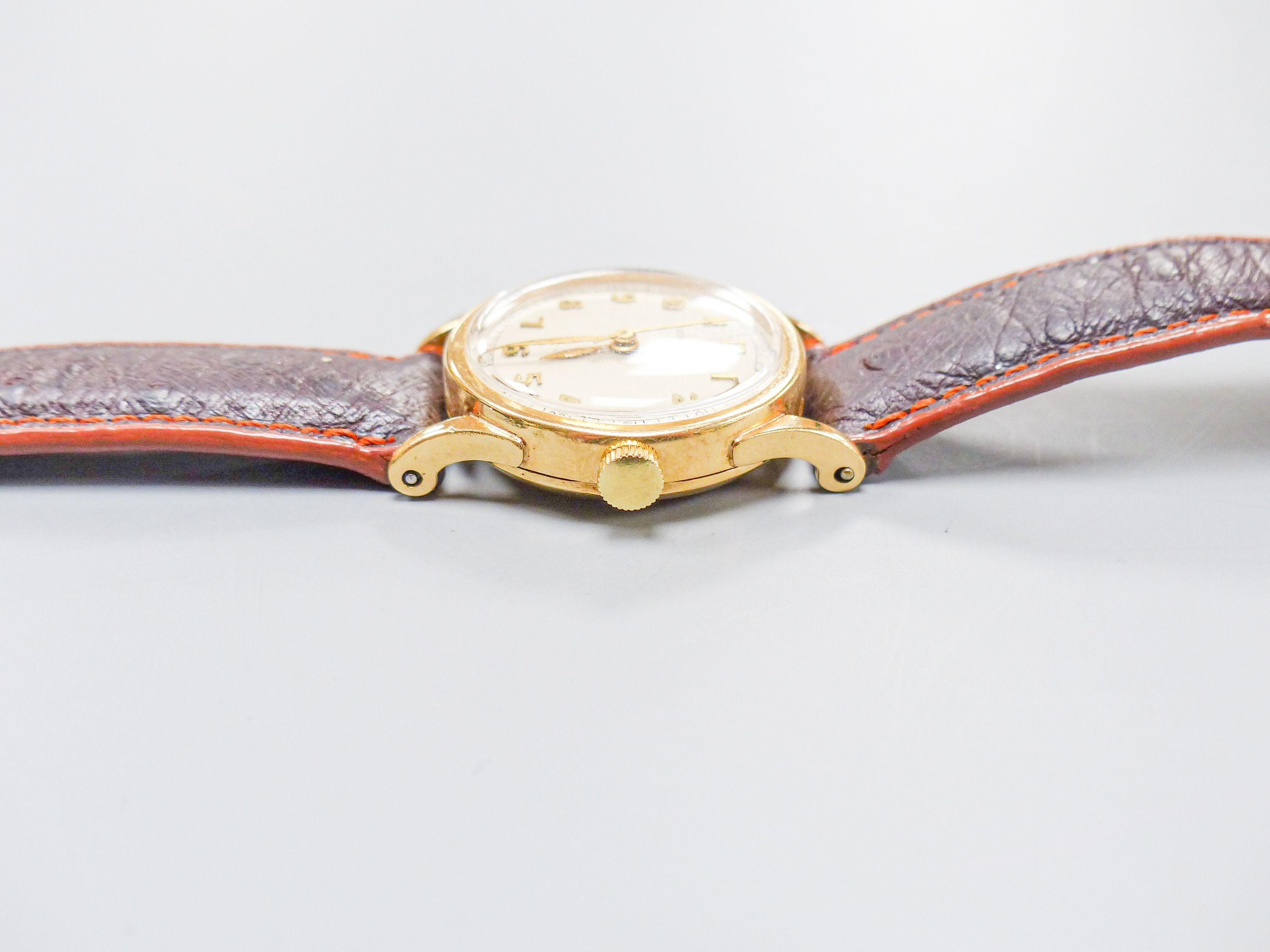 A lady's 14k Tiffany & Co manual wind wrist watch, on associated leather strap, case diameter 27mm, gross weight 28.8 grams.